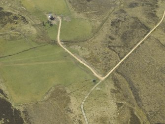 Oblique aerial view centred on the remains of the limekiln with the farmstead adjacent, taken from the NE.