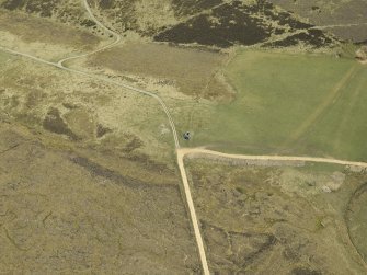 Oblique aerial view centred on the remains of the limekiln, taken from the W.