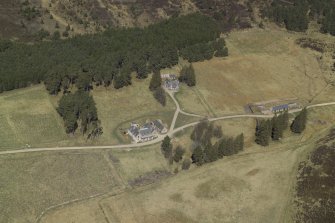 Oblique aerial view centred on the lodge with the keepers house and the kennels adjacent, taken from the S.