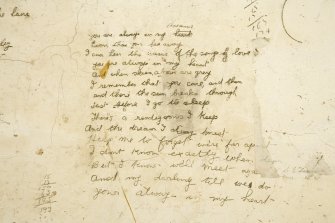 Interior.  Detail of 'poem' on wall of processing room.  The second part is in another hand.