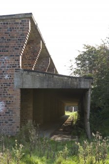View.  Gable end of Processing House showing brick work at roof level and the external verandah.
