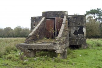 Detail.  Entrance to exposed concrete and brick magazine showing metal doors from SW.