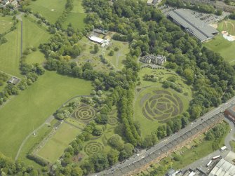 Oblique aerial view of the garden, museum and conservatory, taken from the SW.