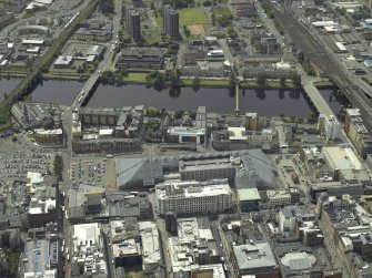 Oblique aerial view centred on the shopping centre with the bridges adjacent, taken from the NNE.