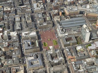 Oblique aerial view centred on the city chambers and square with the station adjacent, taken from the SE.