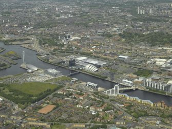 General oblique aerial view centred on the science centre, docks, exhibition centre and bridge, taken from the S.