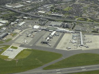 Oblique aerial view of the terminal buildings and apron, taken from the NW.