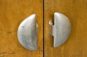 Interior. Ground floor. Main assembly hall door handles. Detail