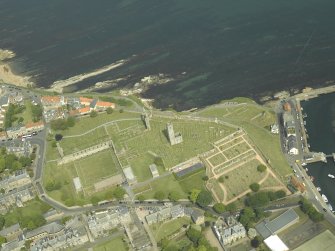 Oblique aerial view centred on the remains of the cathedral with the school adjacent, taken from the SW.