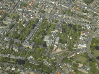 Oblique aerial view centred on the colleges, museum, libraries, church and town hall, taken from the S.