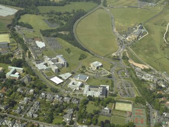 Oblique aerial view of St Andrews centred on the University halls of residences, art gallery, museum and conference centre with the hotel adjacent, taken from the SE.