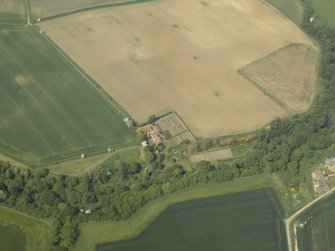 Oblique aerial view centred on the house with the road bridge adjacent, taken from the SE.
