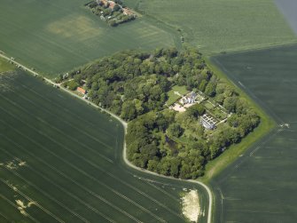 General oblique aerial view centred on the country house, stable block, dovecot and walled garden, taken from the SE.