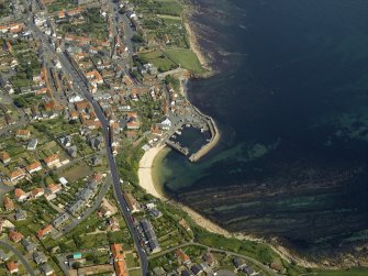 General oblique aerial view of the town centred on the harbour, taken from the SW.