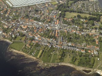 General oblique aerial view of the town centred on the library, school and hotel with the dovecot adjacent, taken from the ESE.