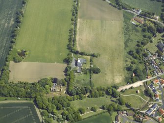 Oblique aerial view centred on the country house, garden and stables with the dovecots adjacent, taken from the W.