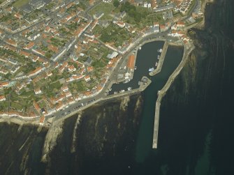 General oblique aerial view of the town centred on the harbour, taken from the SW.