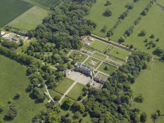 Oblique aerial view centred on the country house, garden and stable with the cottage, farmsteading and stable adjacent, taken from the WNW.