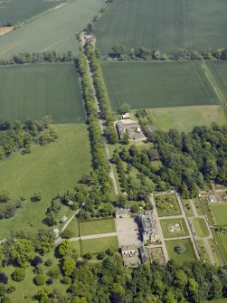 Oblique aerial view centred on the country house, garden and stable with the cottage, farmsteading and stable adjacent, taken from the WSW.