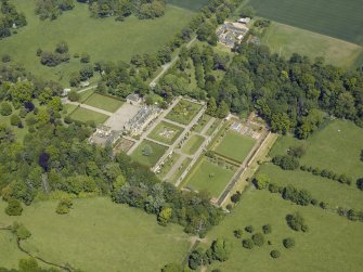 Oblique aerial view centred on the country house, garden and stable with the cottage, farmsteading and stable adjacent, taken from the SW.