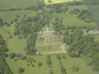 Oblique aerial view centred on the country house, garden and stable with the cottage, farmsteading and stable adjacent, taken from the SE.