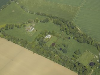 Oblique aerial view centred on the country house and stables, taken from the SW.