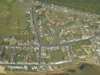 General oblique aerial view of the village centred on the church, churchyard and burial ground, taken from the S.