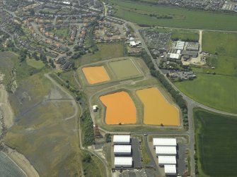 Oblique aerial view centred on the settling ponds, taken from the ENE.