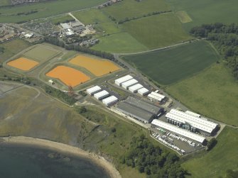 Oblique aerial view centred on the settling ponds, taken from the E.