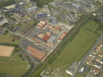 Oblique aerial view centred on the lino works, taken from the SSW.