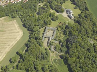 Oblique aerial view centred on the stable block and the country house, taken from the W.