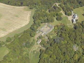 Oblique aerial view centred on the stable block and the country house, taken from the WSW.
