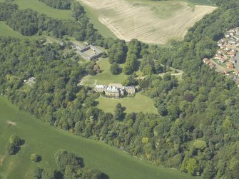General oblique aerial view centred on the country house and stable block, taken from the SE.