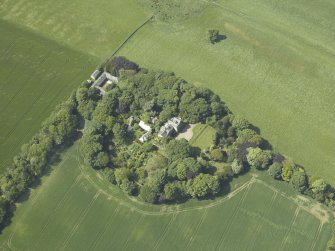 Oblique aerial view centred on the country house, conservatory, dovecot and farmsteading, taken from the ESE.