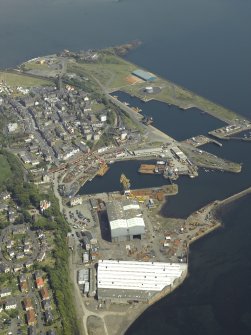 General oblique aerial view centred on the harbour, taken from the W.