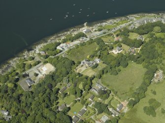 General oblique aerial view centred on the town and country house, taken from the NE.