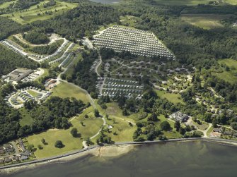  Oblique aerial view centred on the house and the adjacent holiday village, taken from the NE.