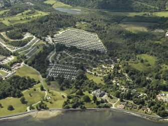 Oblique aerial view centred on the house and the adjacent holiday village, taken from the NE.