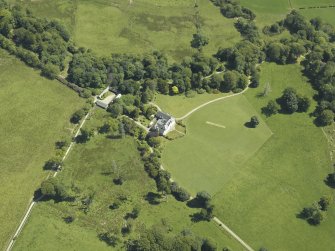 Oblique aerial view centred on the house, taken from the W.