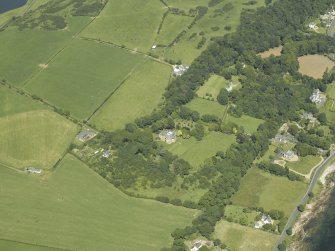 Oblique aerial view centred on the castle and country house, taken from the SSE.