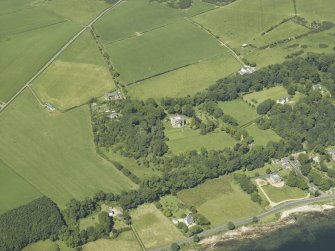 Oblique aerial view centred on the castle and country house, taken from the SE.