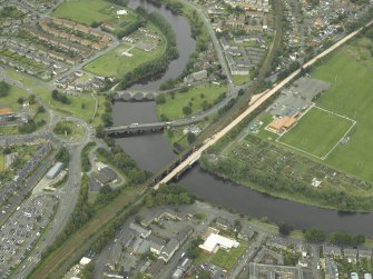 Oblique aerial view of North Stirling showing the railway junction of Stirling to Alloa railway with main Stirling to Perth line. Also visible are the other bridges across the Forth from SE.
