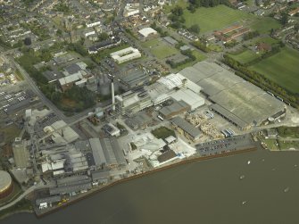 Oblique aerial view.  Alloa Glass Works, gasholder and harbour from SW.