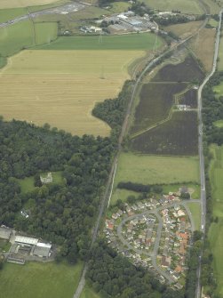 Oblique aerial view.  Reconstruction works for rebuilding railway from Alloa, Old Tulliallan Castle, Hawkhill and Kilbagie in the background from S.