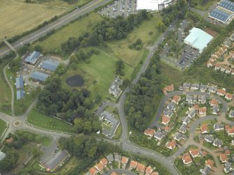 General oblique aerial view centred on the tower-house, farmsteading, stables and garden, taken from the NE.