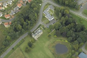 Oblique aerial view centred on the tower-house, farmsteading, stables and garden, taken from the SW.