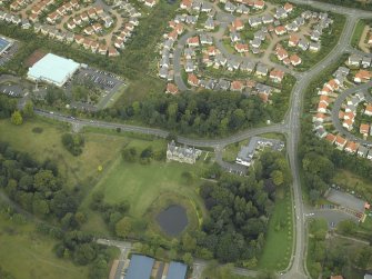 Oblique aerial view centred on the tower-house, farmsteading, stables and garden, taken from the SSE.