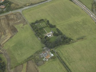 Oblique aerial view centred on the house, walled garden and gate piers, taken from the SW.