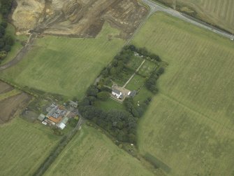 Oblique aerial view centred on the house, walled garden and gate piers, taken from the SE.