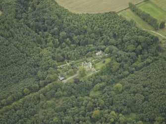 Oblique aerial view centred on the castle, garden and chapel, taken from the NE.